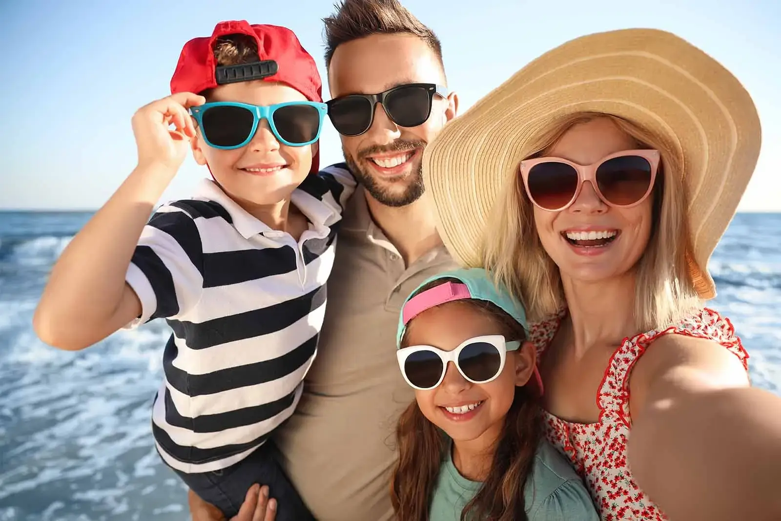 Family with sunglasses at the beach.