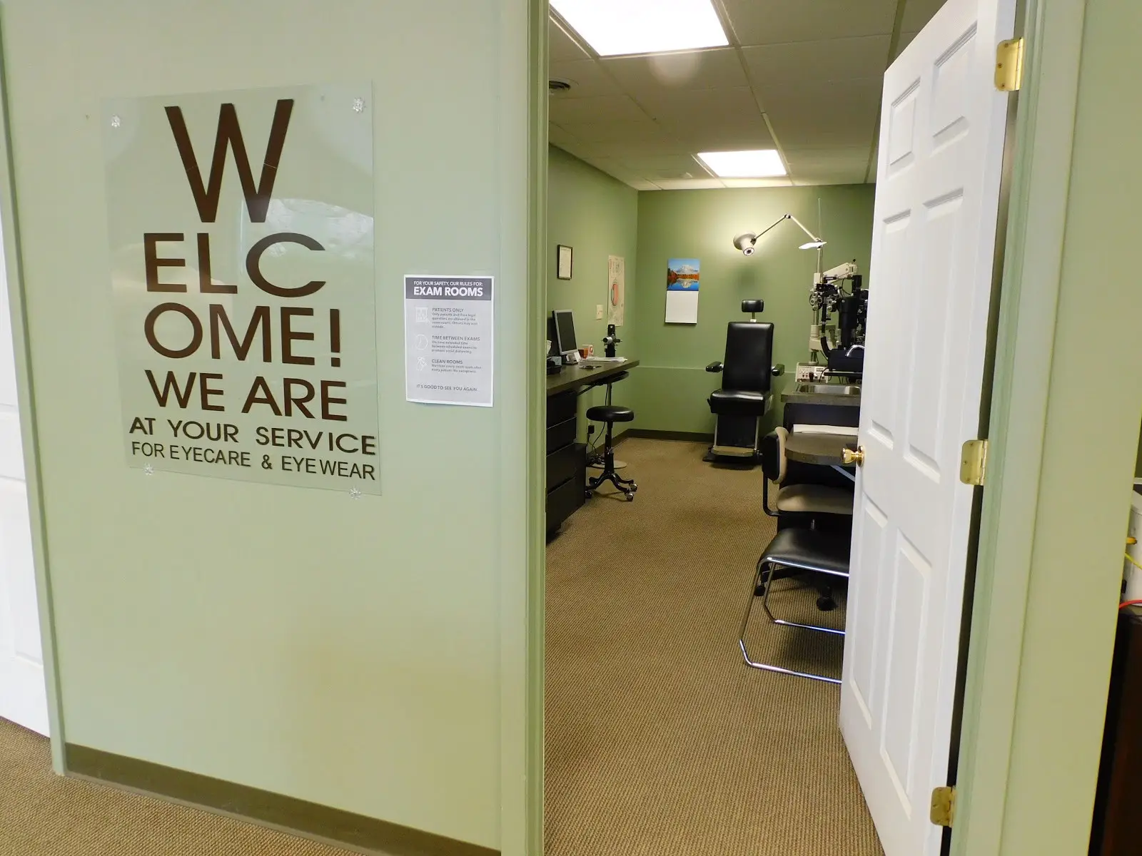 Exam room with chairs and eye exam equipment.