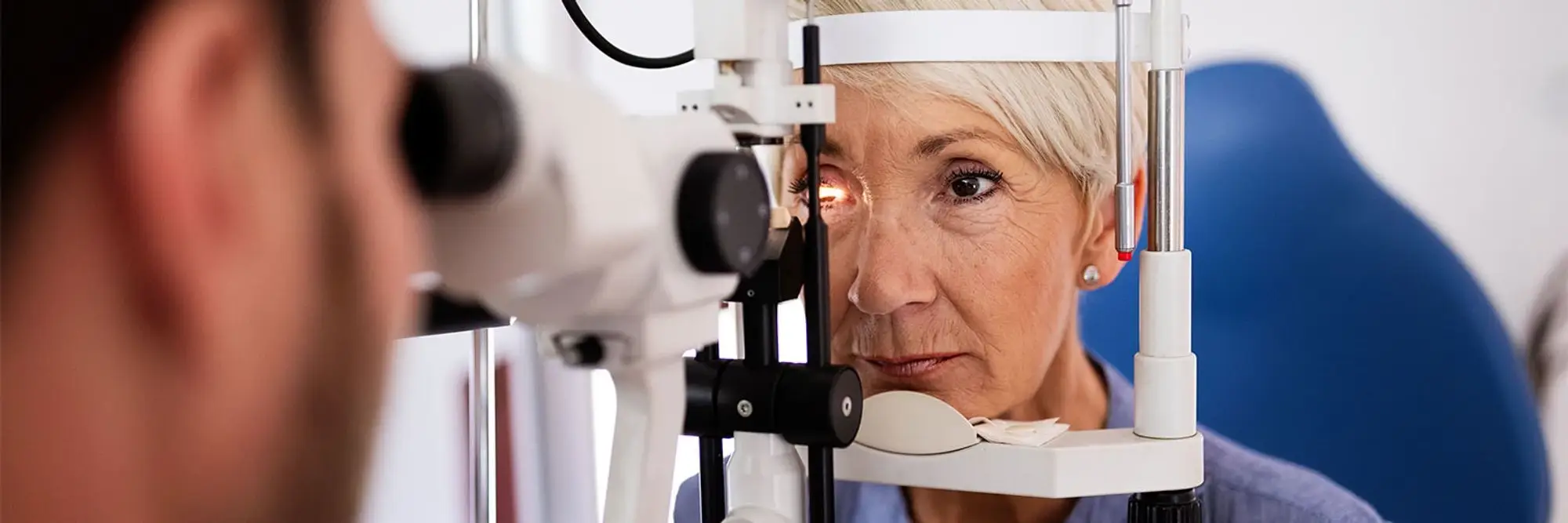 A patient receives an eye exam.