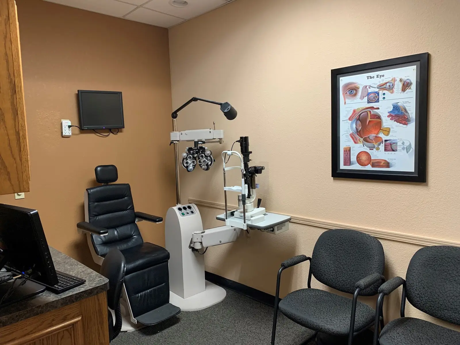 Exam room with medical equipment and chairs at Potranco EyeTX.