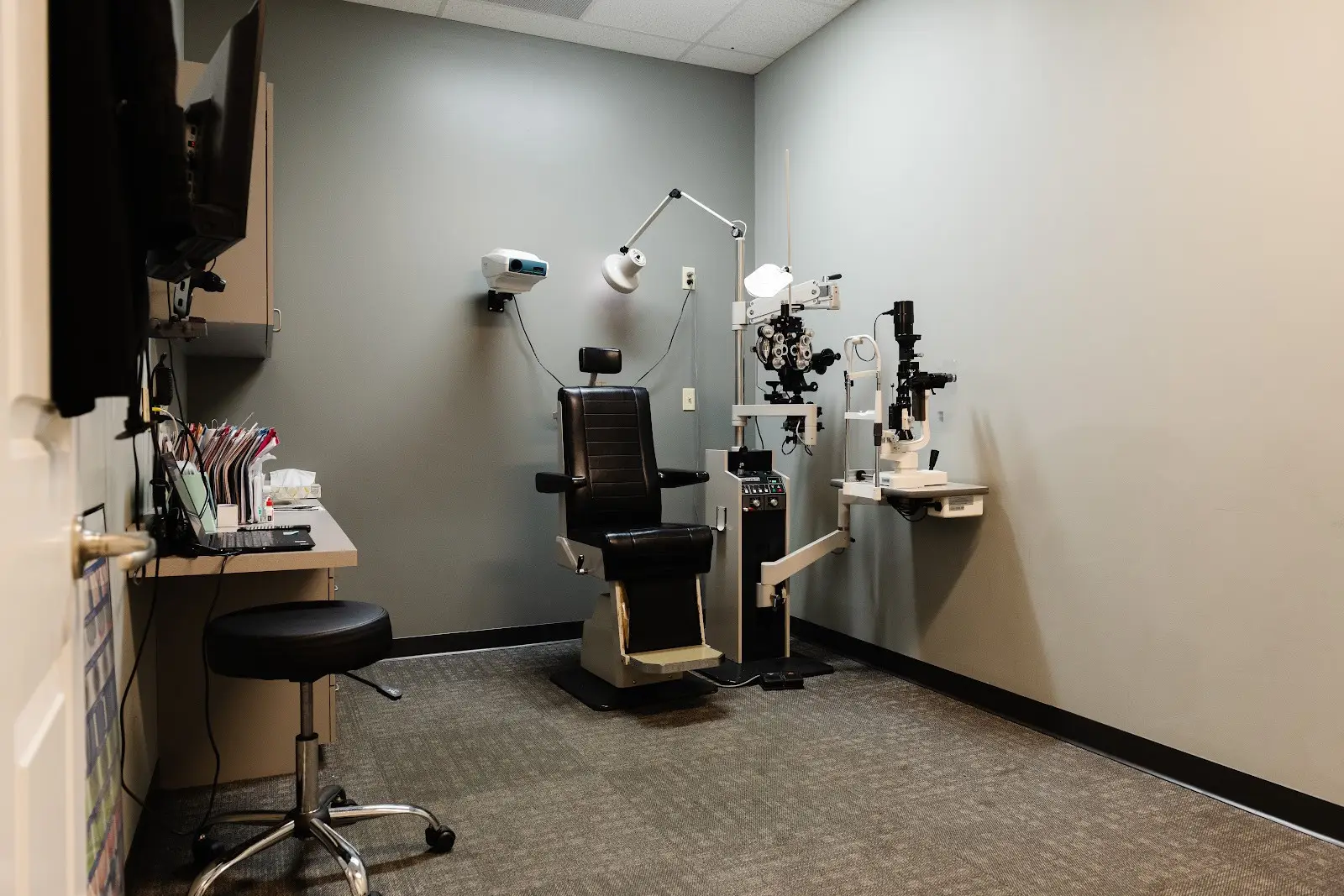 Eye exam room with medical equipment.