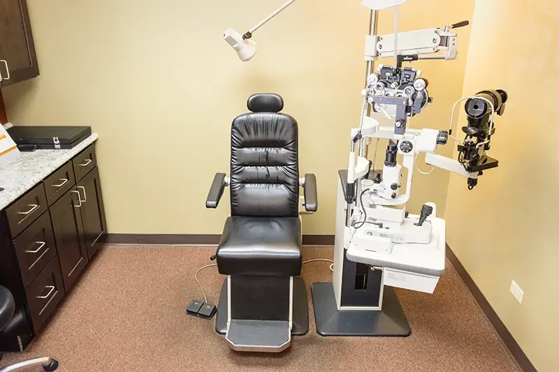 Exam room with eye testing medical equipment at Primary Eye Care Centers - Crystal Lake