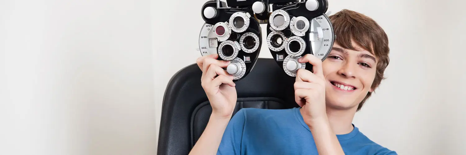 Young male teen at an eye doctor's office for an eye exam.