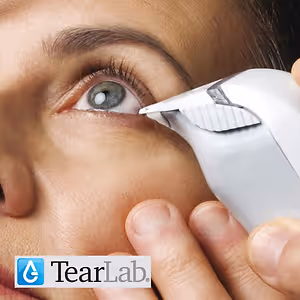 A woman using a TearLab device on her eye.