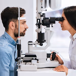 man having his eyes examined by a woman doctor
