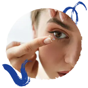 woman inserting a contact lens into her eye