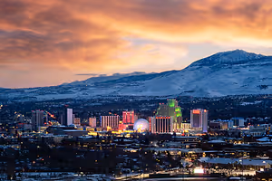 Reno Nevada skyline at dusk with mountains in the background