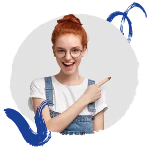 A woman wearing glasses and a white shirt with denim overalls is pointing at the camera and smiling