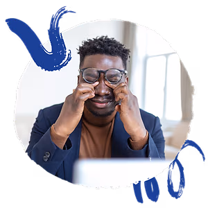 business man adjusting glasses with a laptop in the background