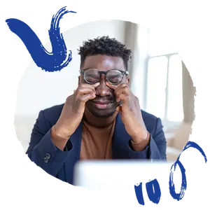 business man adjusting glasses with a laptop in the background
