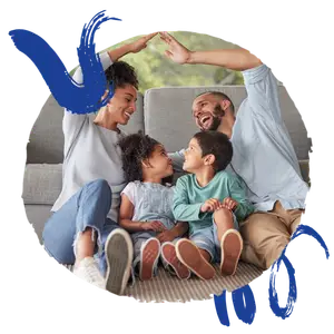 A family sitting on a couch with two kids. The dad is raising his arms and the mom is raising her arms. The kids are looking at each other.