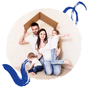 A happy family of four posing for a photo while wearing casual clothes and sitting on the floor.