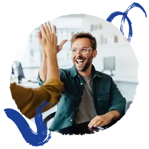 Man and woman in an office high fiving with a smile on his face