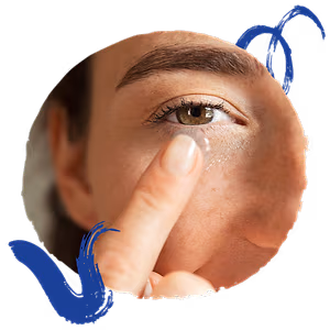 A woman puts a contact lens in her eye