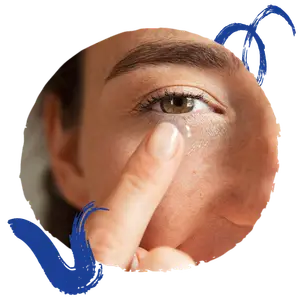 A woman puts a contact lens in her eye