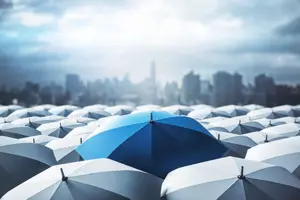 Umbrellas in the rain with text promoting quality vision care and insurance benefits at Eye E Optical