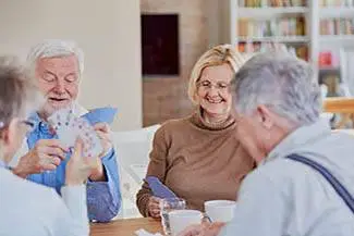Seniors playing card games in the living room