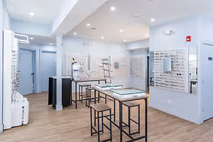 Wesley Eye Care optometric practice with wooden flooring and a white wall with a glass display board