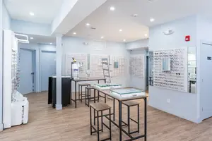 Wesley Eye Care optometric practice with wooden flooring and a white wall with a glass display board