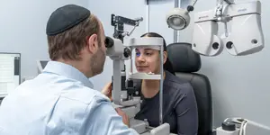 woman undergoing an eye exam with Dr. A. Tzvi-Gottesman