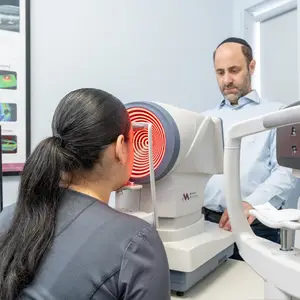 woman undergoing an eye exam with Dr. A. Tzvi Gottesman