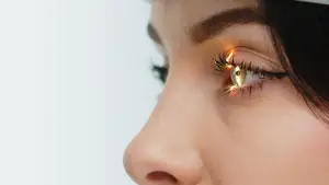 Gray TN Woman with black hair and light brown eyes with a yellow light reflection in the iris