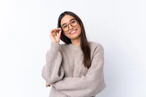 woman with glasses smiling and wearing a sweater