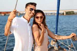 Man holding a rope while woman touching her face with a tattoo on her right arm