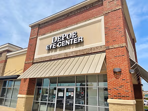 An outside view of the Depo Eye Center building with a blue sky and clouds in the background.