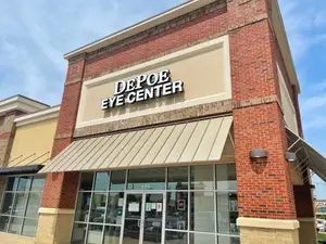 An outside view of the Depo Eye Center building with a blue sky and clouds in the background.