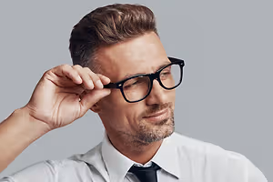business man adjusting glasses