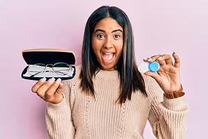 Woman showing a box of eyeglasses and blue contact lenses