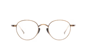 Close-up view of a pair of gold-rimmed glasses with oval lenses