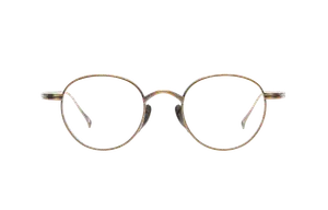 Close-up view of a pair of gold-rimmed glasses with oval lenses