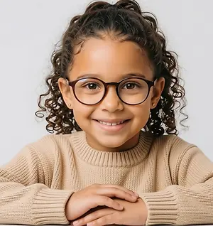 Smiling child wearing round eyeglasses and a beige sweater