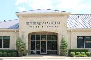 Exterior of Eye Q Vision Smart Eyecare building with sign and shrubs