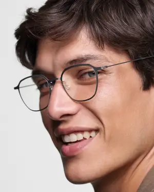 Close-up of a man with glasses and short hair smiling