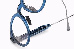 Blue-framed glasses with adjustable nose pads on a white background