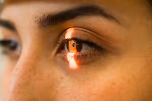 Close-up of a female's eye with a light reflection on the iris