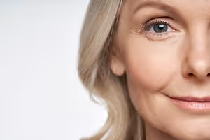 Close-up portrait of a smiling woman with blue eyes