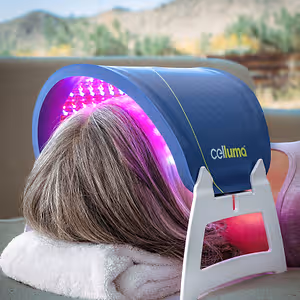 Person receiving red and purple LED light therapy with a Celluma device