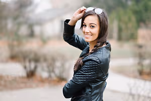 young woman looking over shoulder with sunglasses