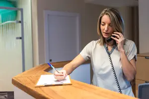 Woman writing on clipboard