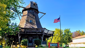 Pleasant View Mill with American flag and sign in front of it