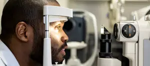 man having comprehensive eye exam for contact lenses
