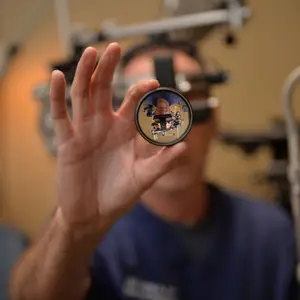 dr hart holding eye exam magnifying lens