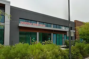 Exterior of the Saratoga Vision Center building with glass windows and a wooden awning.