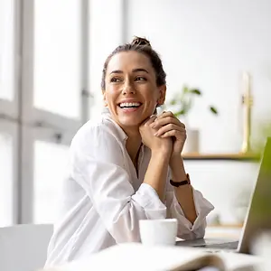 woman smiling while working at a desk