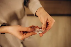 A woman holding a transparent object in her hands in a room