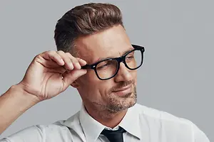 business man adjusting glasses